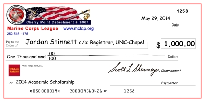 image of the large-scale mock check presented to previous scholarship recipient